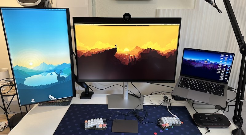 Dell U3224KB on desk, surrounded by vertical monitor and laptop