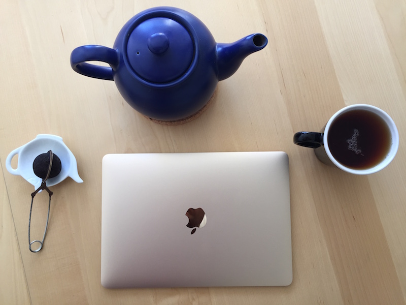 2015 Macbook on table, with common tea utensils for reference