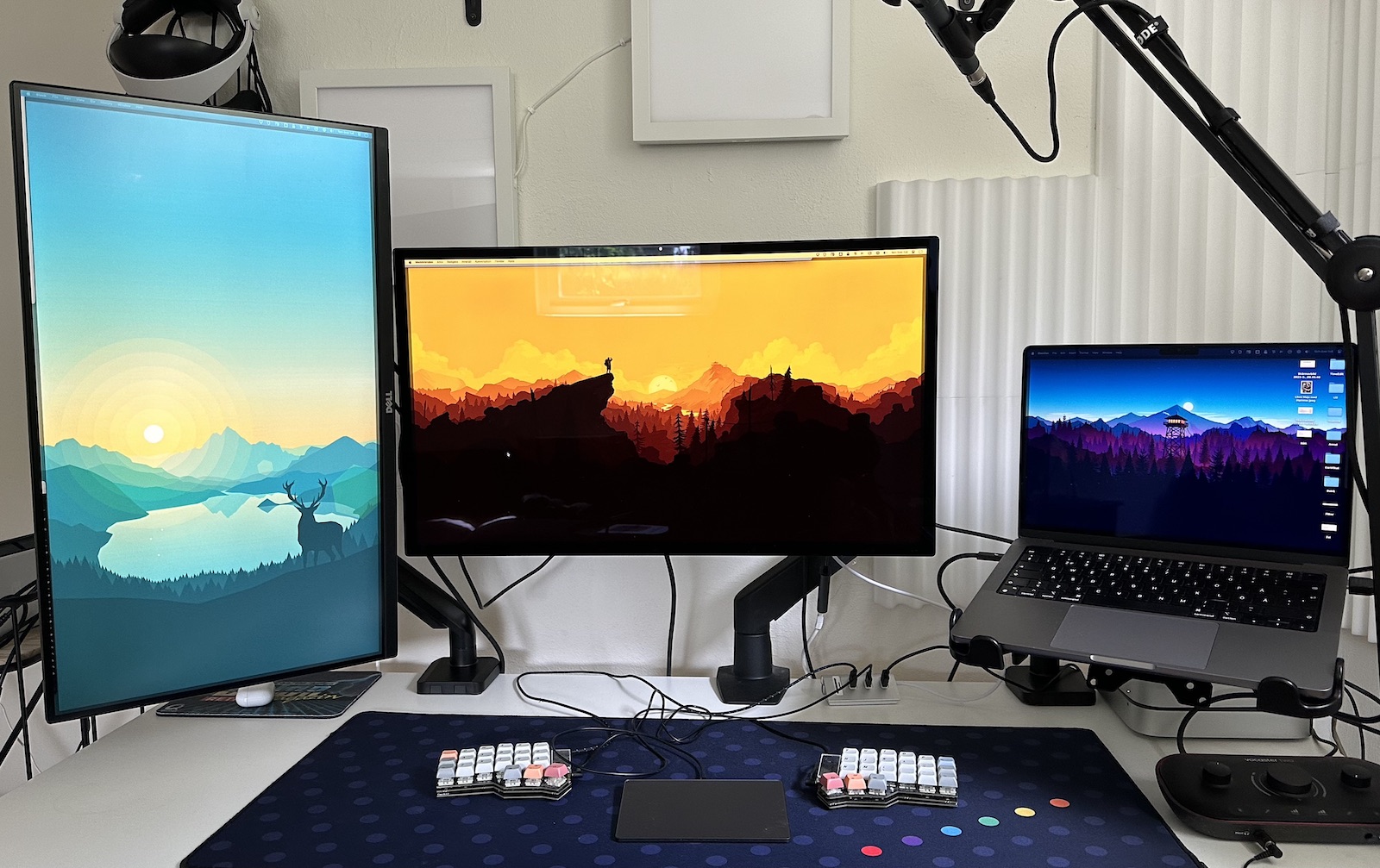 Two screens and a laptop on VESA arms